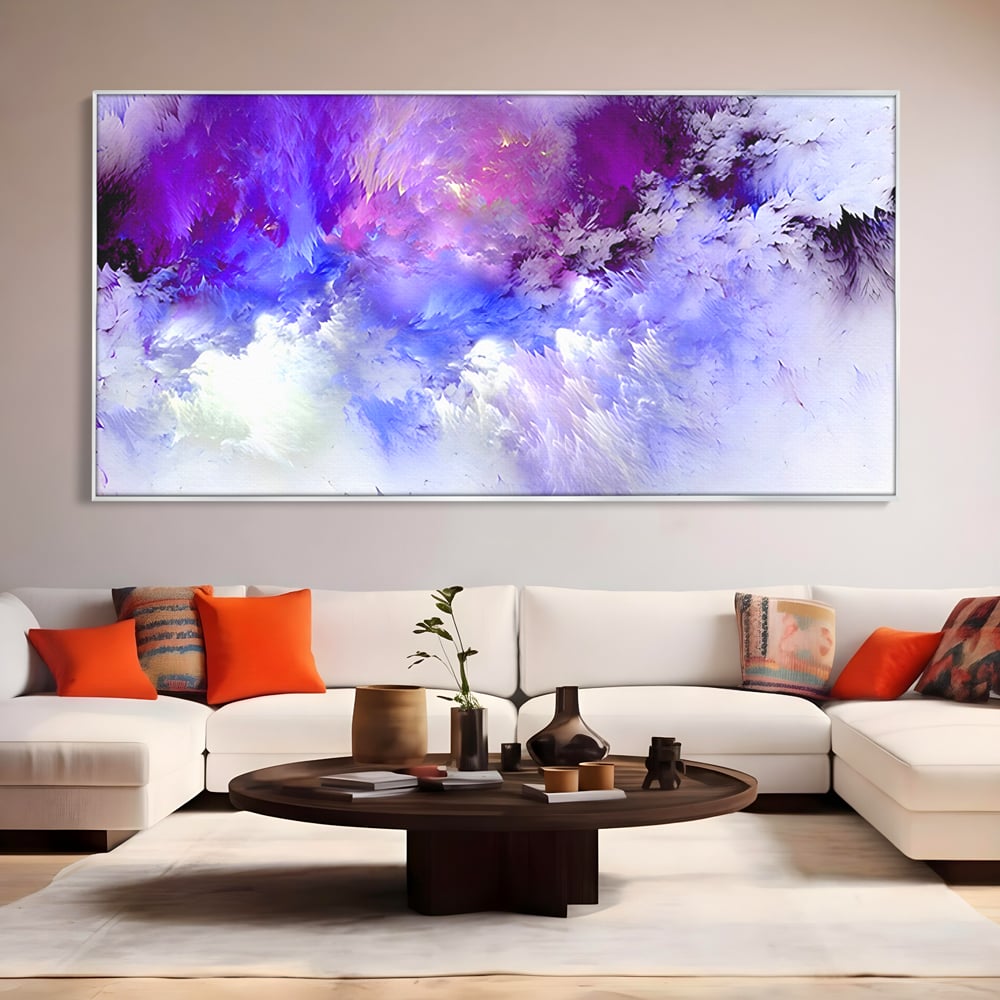 Tablou canvas cu pictura abstracta cu nori mov si albastri, in rama de aluminiu argintiu, pe perete intr-un living